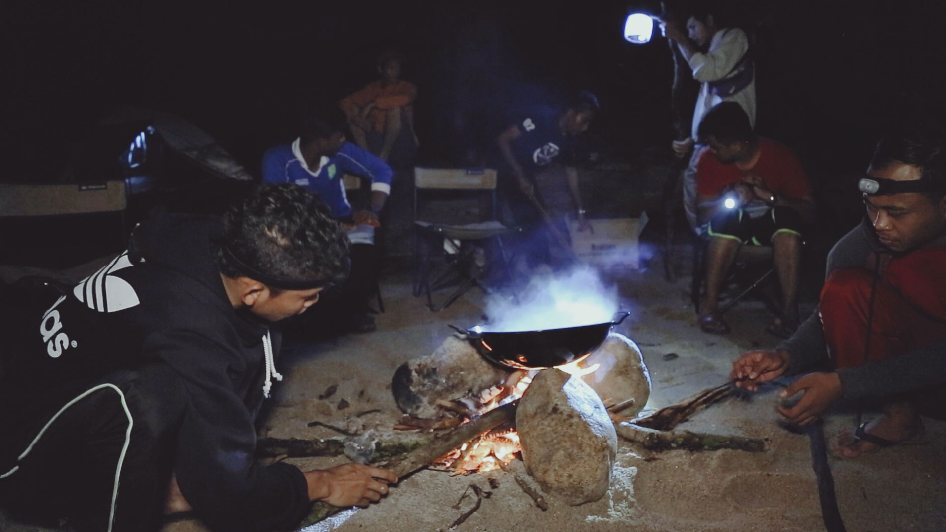 G-Team meticulously keeps the man-made stove running by feeding it with dry wood in Perak.